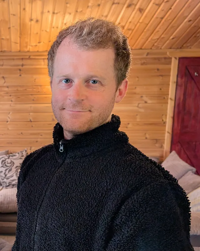 Liam Humphreys, founder of TurboKast Studio, smiling in a fleece jacket